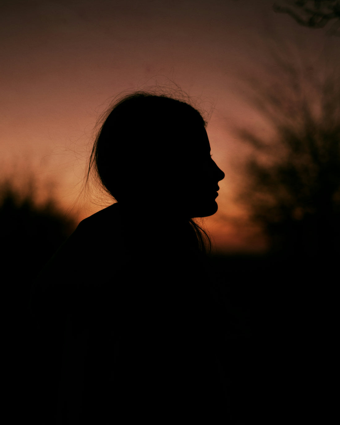 Silhoette of a young girl at sunset, by Alina Chernovolova
